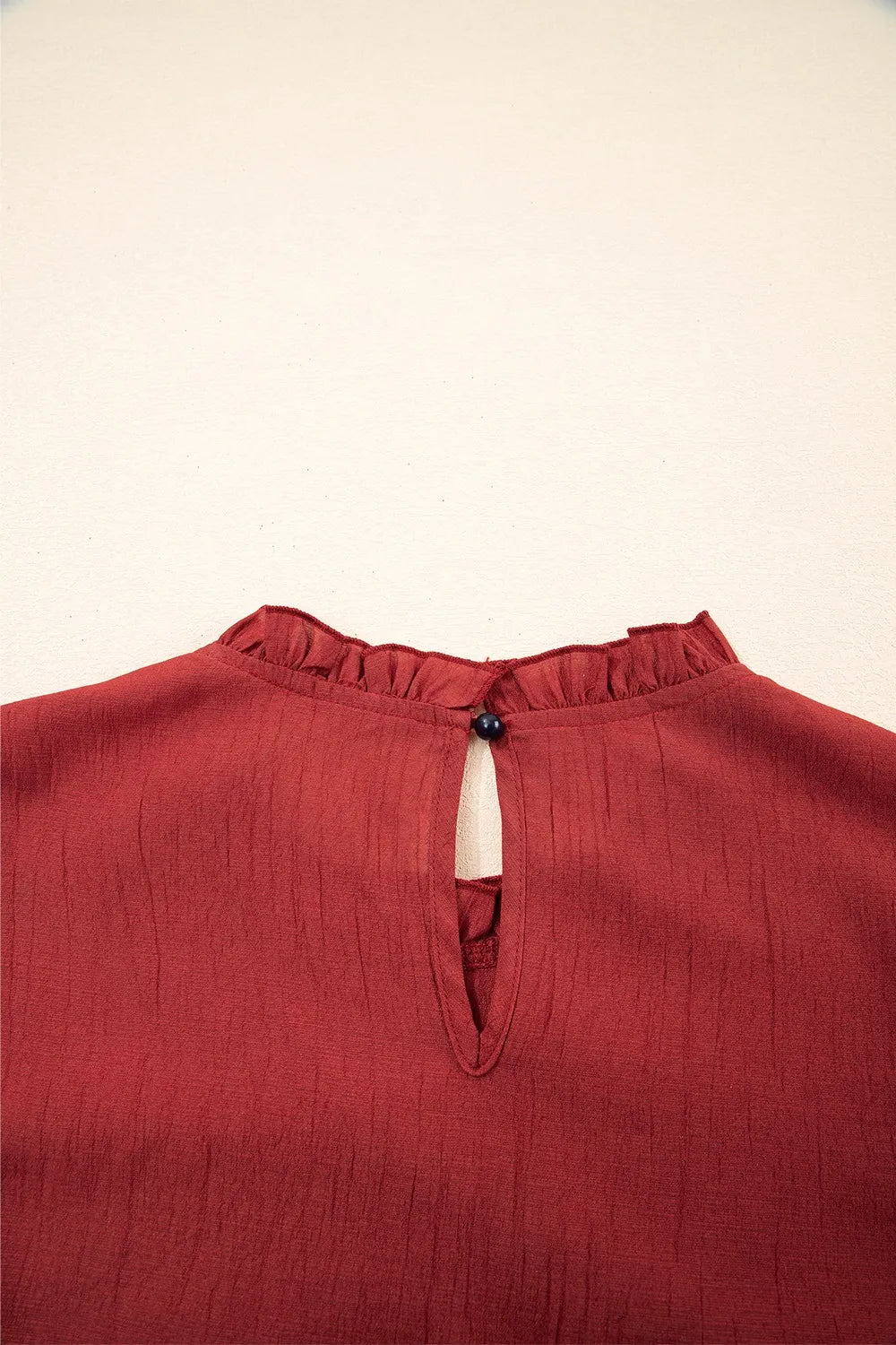 Dahlia Solid Color Pleated Detail Ruffle Short Sleeve Blouse