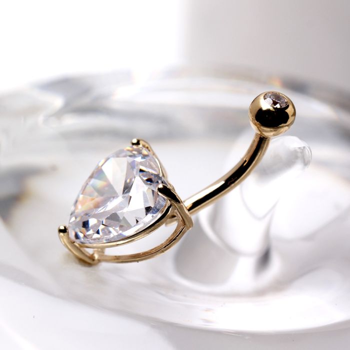 14Kt Yellow Gold Navel Ring with Large Clear Heart Prong Set CZ14Kt Yellow Gold Navel Ring with Large Clear Heart Prong Set CZThis classic large heart prong set navel ring is sure to make an impression. It is simple yet a beautiful piece of jewelry. Featu